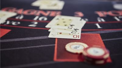 Cards, chips, and tokens on a casino table with words like
