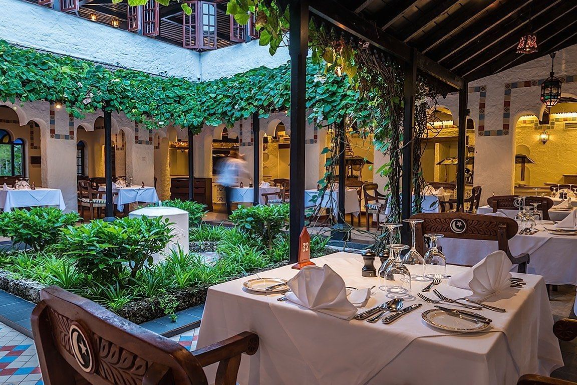 Outdoor dining with pond view at Serena Beach Resort & Spa