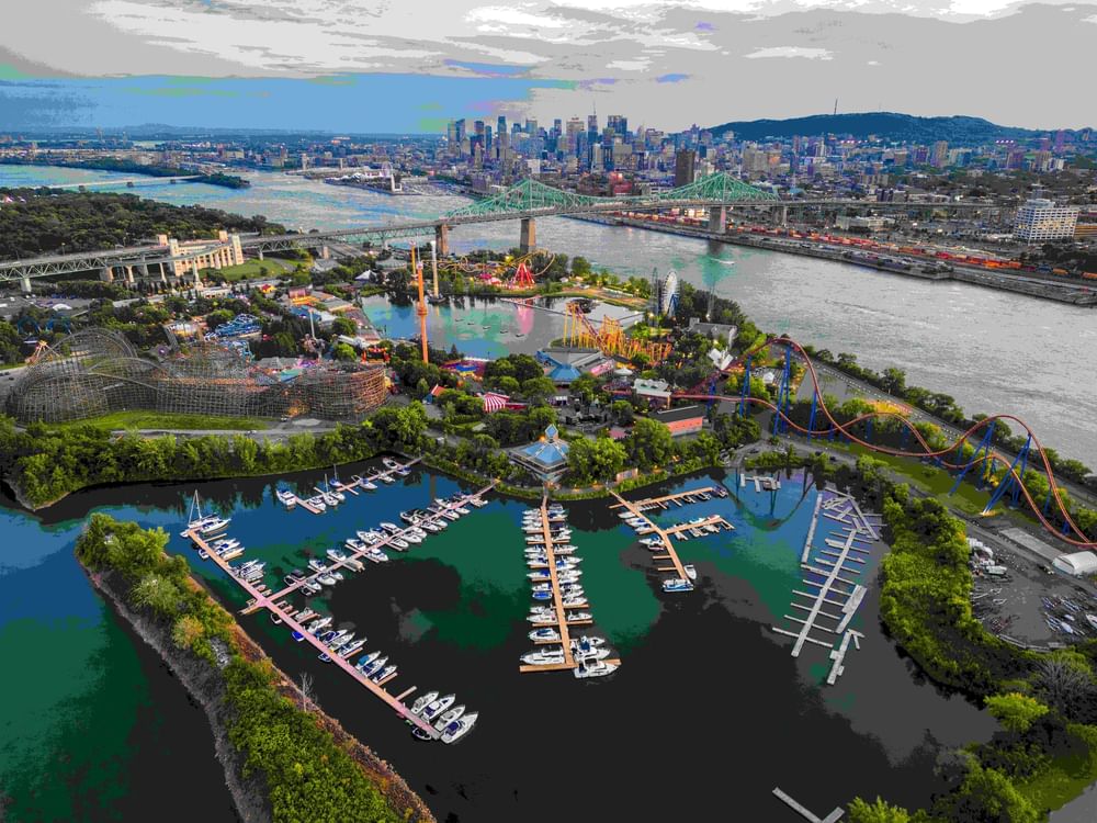 Aerial view of Montreal showing amusement park, marina, green bridge, and downtown skyline at Warwick Le Crystal Montreal