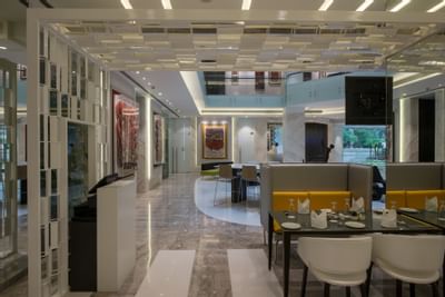Arranged dining area by the reception in The Glass House at Eastin Residences Vadodara