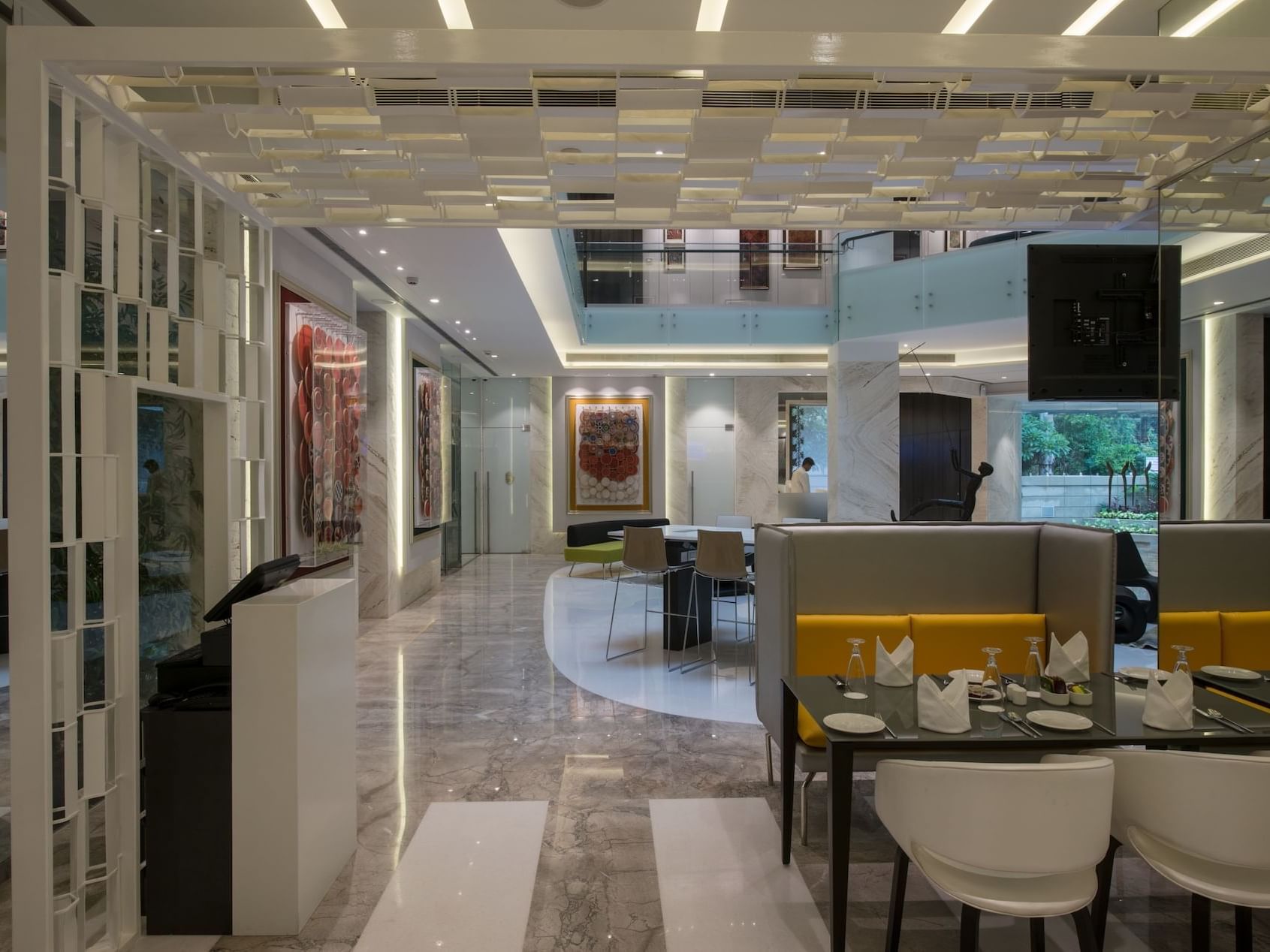 Arranged dining area by the reception in The Glass House at Eastin Residences Vadodara