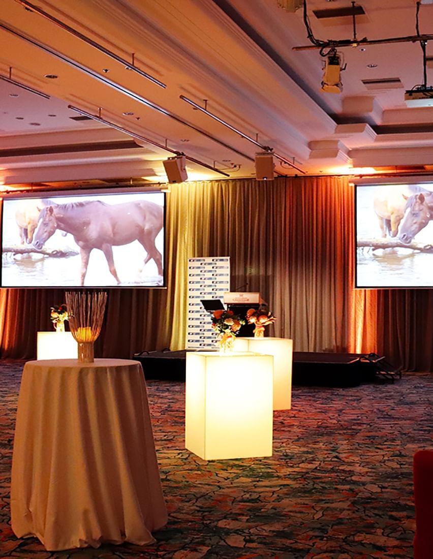 Digital screens with round tables and deco in the hall at Hotel Grand Chancellor Adelaide
