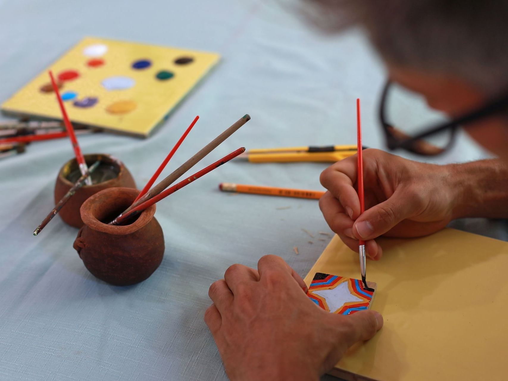 Closeup of a Man painting a picture at Punta Islita Hotel