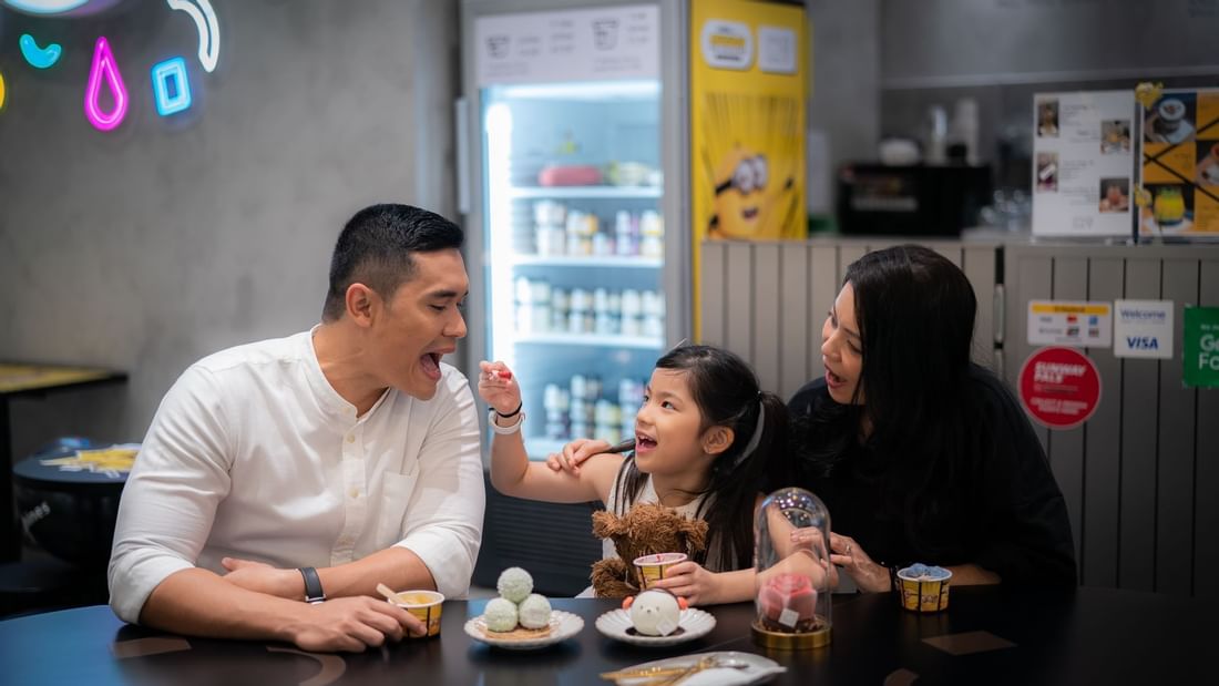 A family of 3 dining in a mall near Sunway Resort