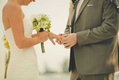 Groom placing the wedding ring on bride at The Danna Langkawi