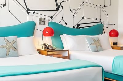 Visual showing two double beds and the bathroom