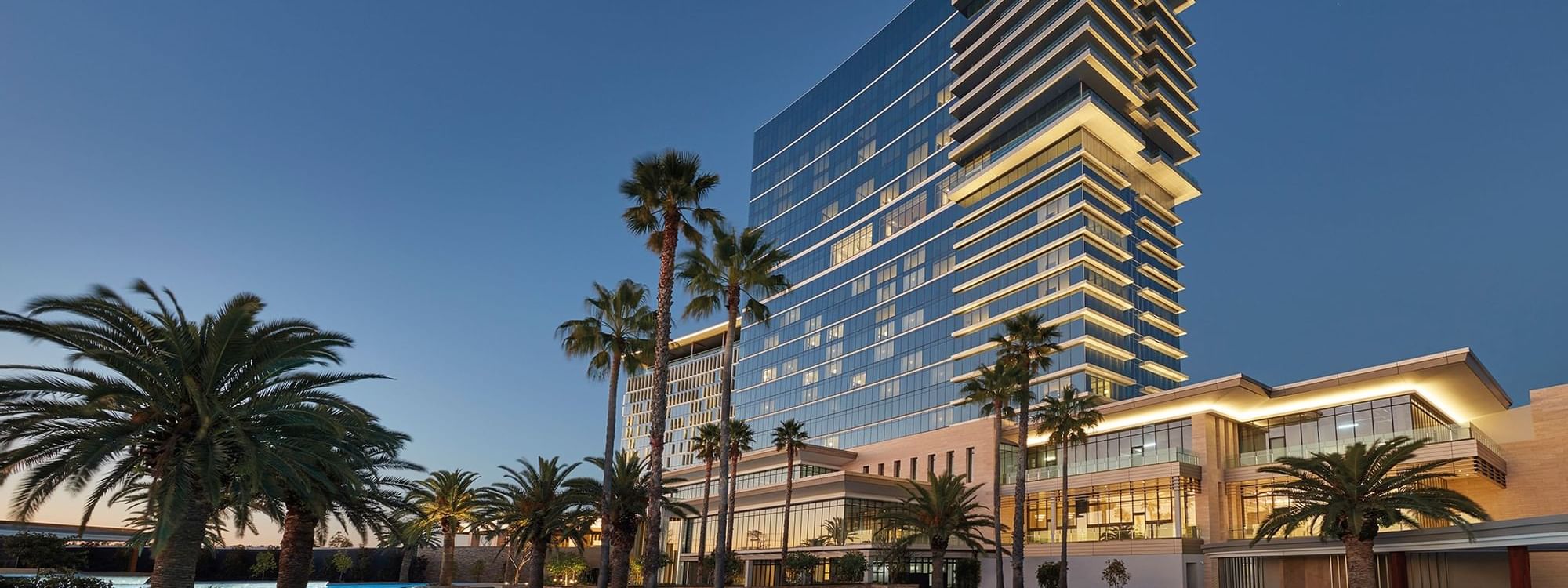 Night view of the Pool complex by the Crown Towers Perth façade
