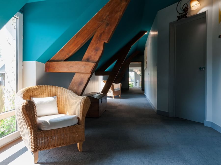 Sofa chair in a corridor at Hotel La Cour Carree