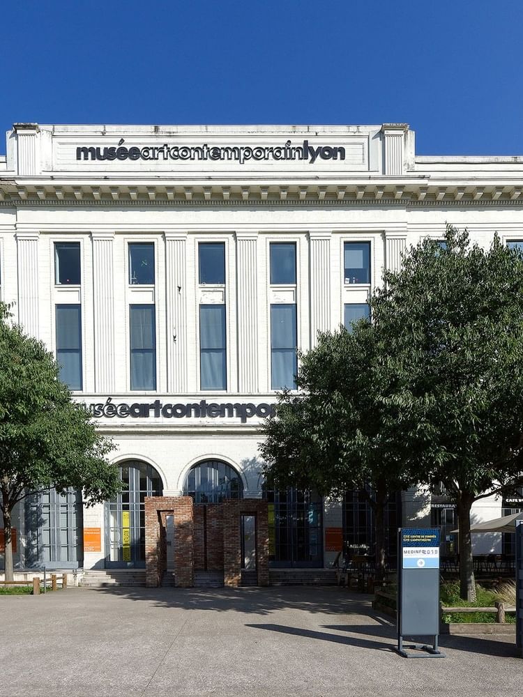 Museum of Contemporary Art of Lyon, surrounded by trees and a clear blue sky near Warwick Reine Astrid Lyon