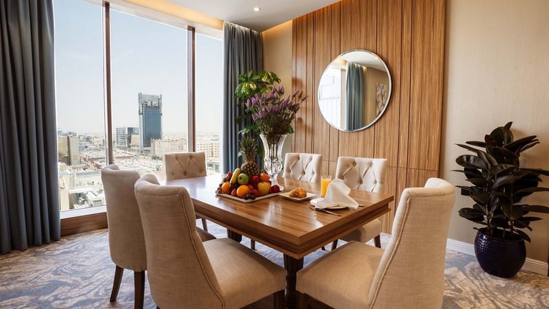 Comfortable dining table with city view at Cantonal Hotel by Warwick Riyadh