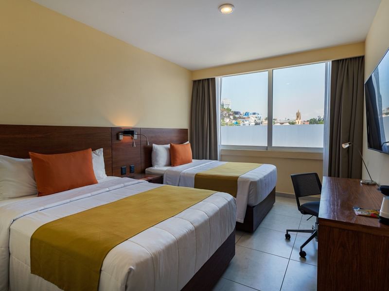 Two beds & TV station in the Superior Room at Gamma Hotels