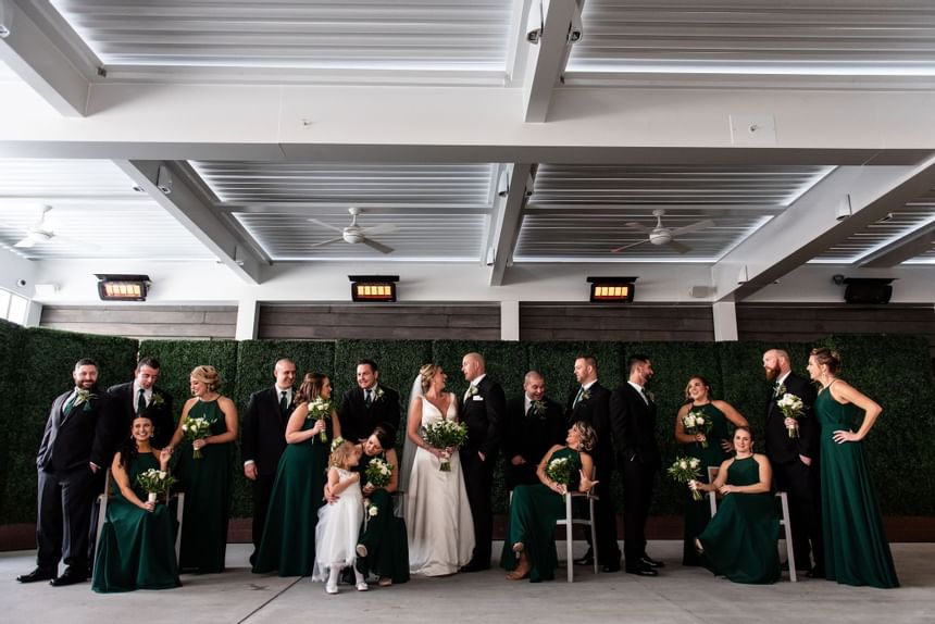 A large wedding party poses for a photo at our Avalon wedding venue