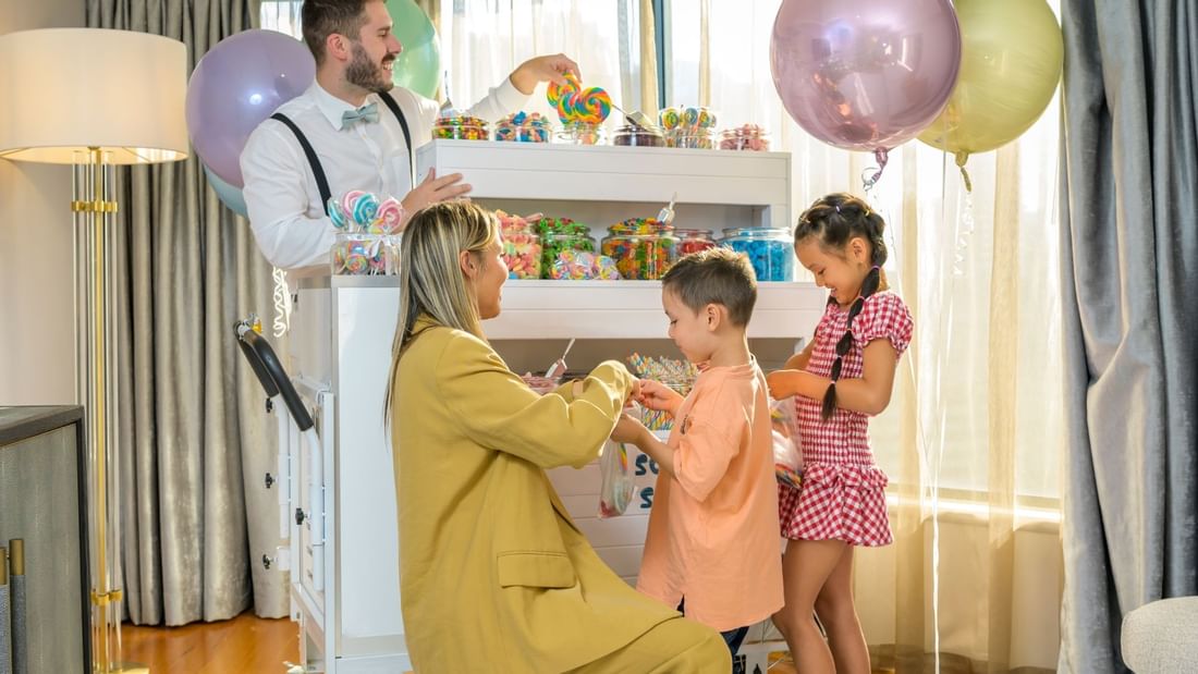 Mother buying candy for her children from a cart at Pullman Sydney Hyde Park