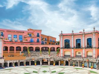 Beautiful pink colonial architecture surrounding a large stone courtyard at Quinta Real Zacatecas