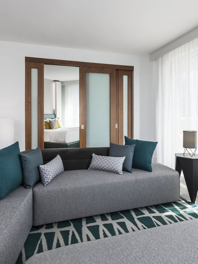 Living space with a large sofa near window in Warwick Premier at Warwick Le Crystal Montreal