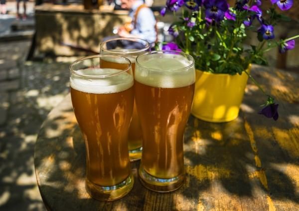 Beers served on a wooden table in Frankie Farrell’s Irish Pub & Grill at Lake Buena Vista Resort Village & Spa