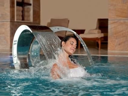 Lady at pool in Coral Beach Gem Spa at Grand Fiesta Americana