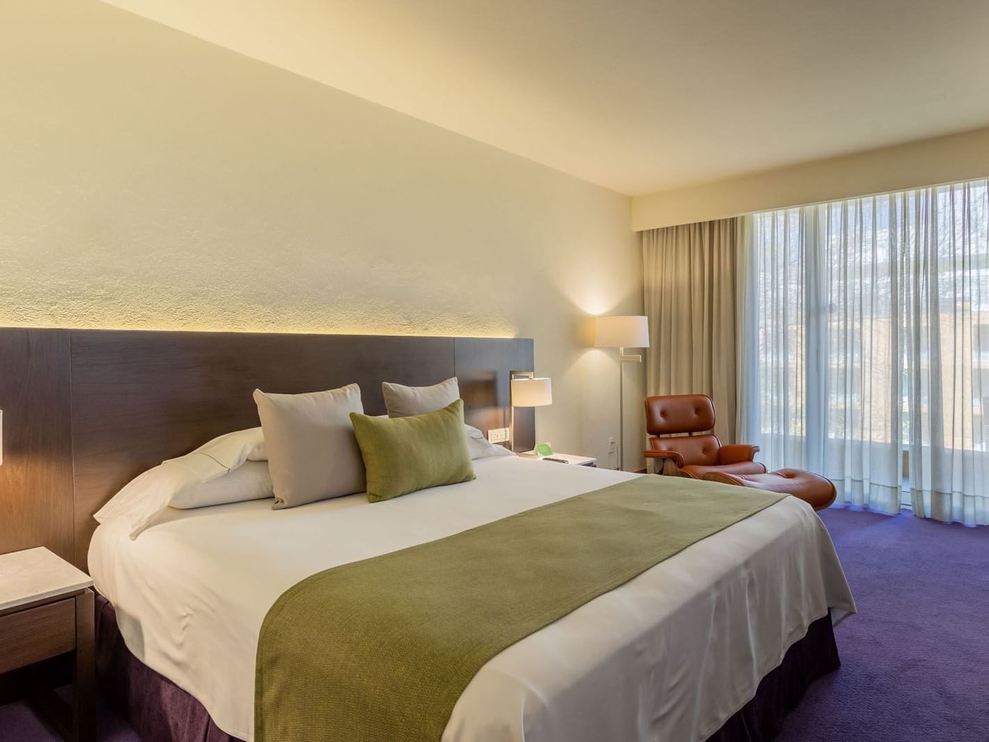 King Camino Real Club with a green runner, purple carpet, and a leather lounge chair at Camino Real Polanco Mexico