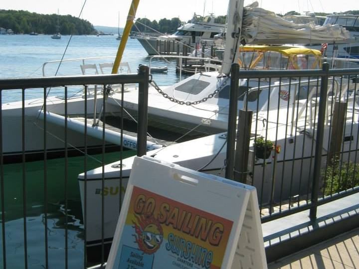 Sunshine Boat Charters parked by the deck on Lake Michigan near The Earl