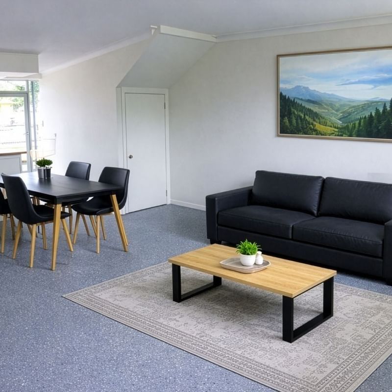 Living room with couch, coffee table, dining set, and TV at UniLodge SCU Lismore - Sirius.
