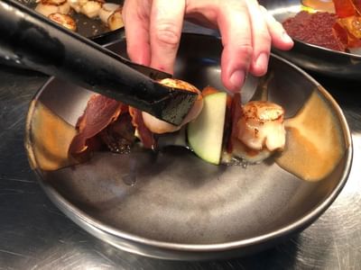 Close-up of a person preparing a dish at Orsett Hall Hotel