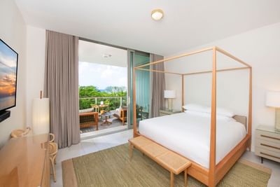 S202 Room with a wooden four-poster bed and large windows with a view of a balcony in The Residences at Seafire