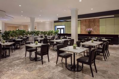 Dining area with marble flooring in the Coffee Bar at York Hotel Singapore