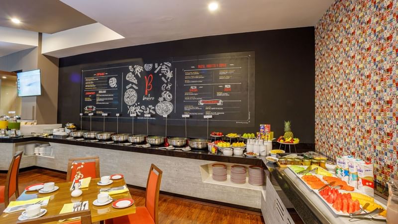 Breakfast buffet in Bistro featuring fresh fruit, cereal, and a chalkboard menu at Camino Real Pachuca
