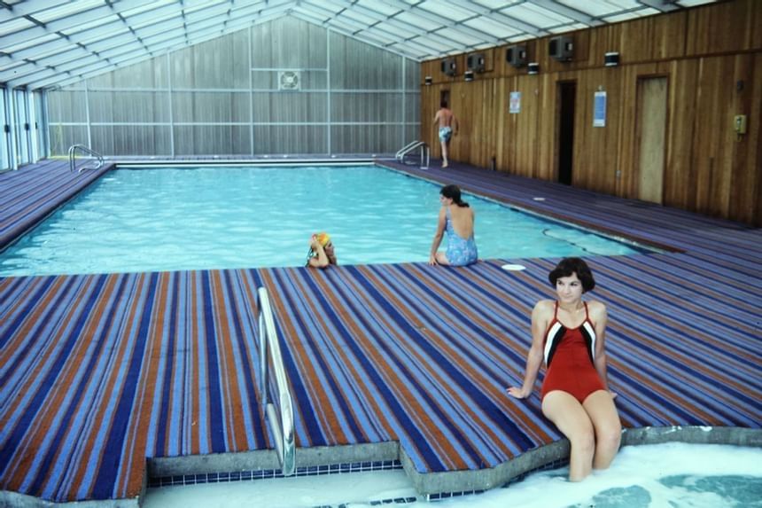 Two ladies relaxing by the indoor pool edge at Alderbrook Resort & Spa