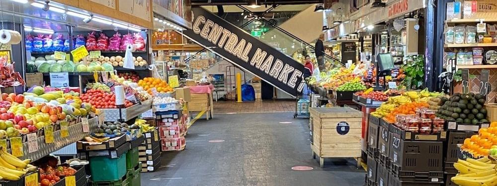 Central Market featuring fresh produce stalls and a prominent Central Market sign near Ibis Adelaide