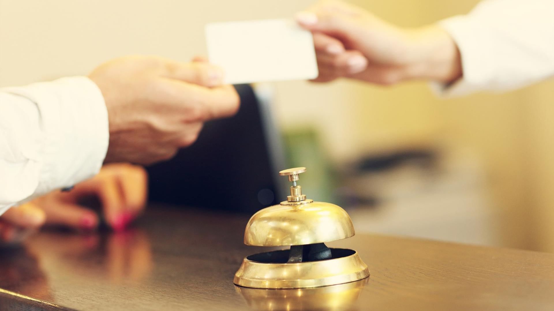 Receptionist hand over the key card to a guest at Titanic Mardan Palace