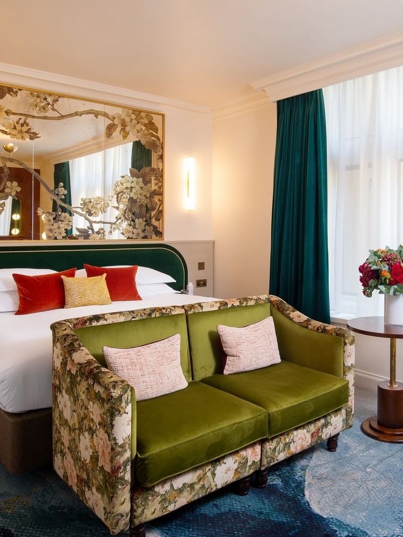 Deluxe King with a bed, chairs & coffee table near the window at The Capital Hotel, Apartments, and Townhouse
