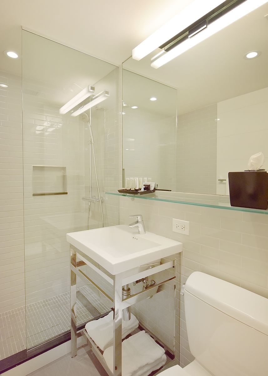 A clean bathroom with a shower, sink, and toilet