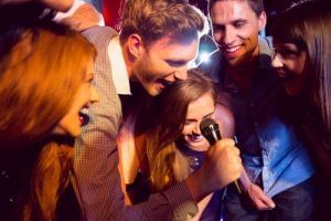 Friends singing karaoke at the Nightclub, Rosen Inn Universal