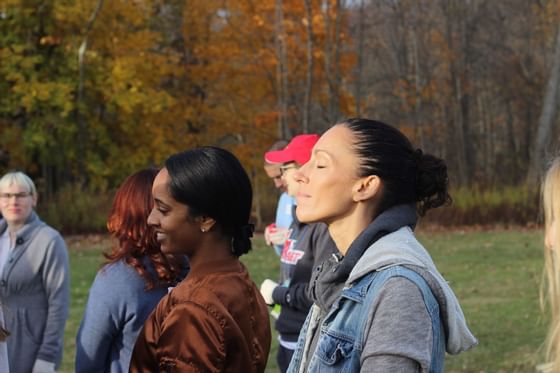 People meditating in a park near Honor's Haven Retreat