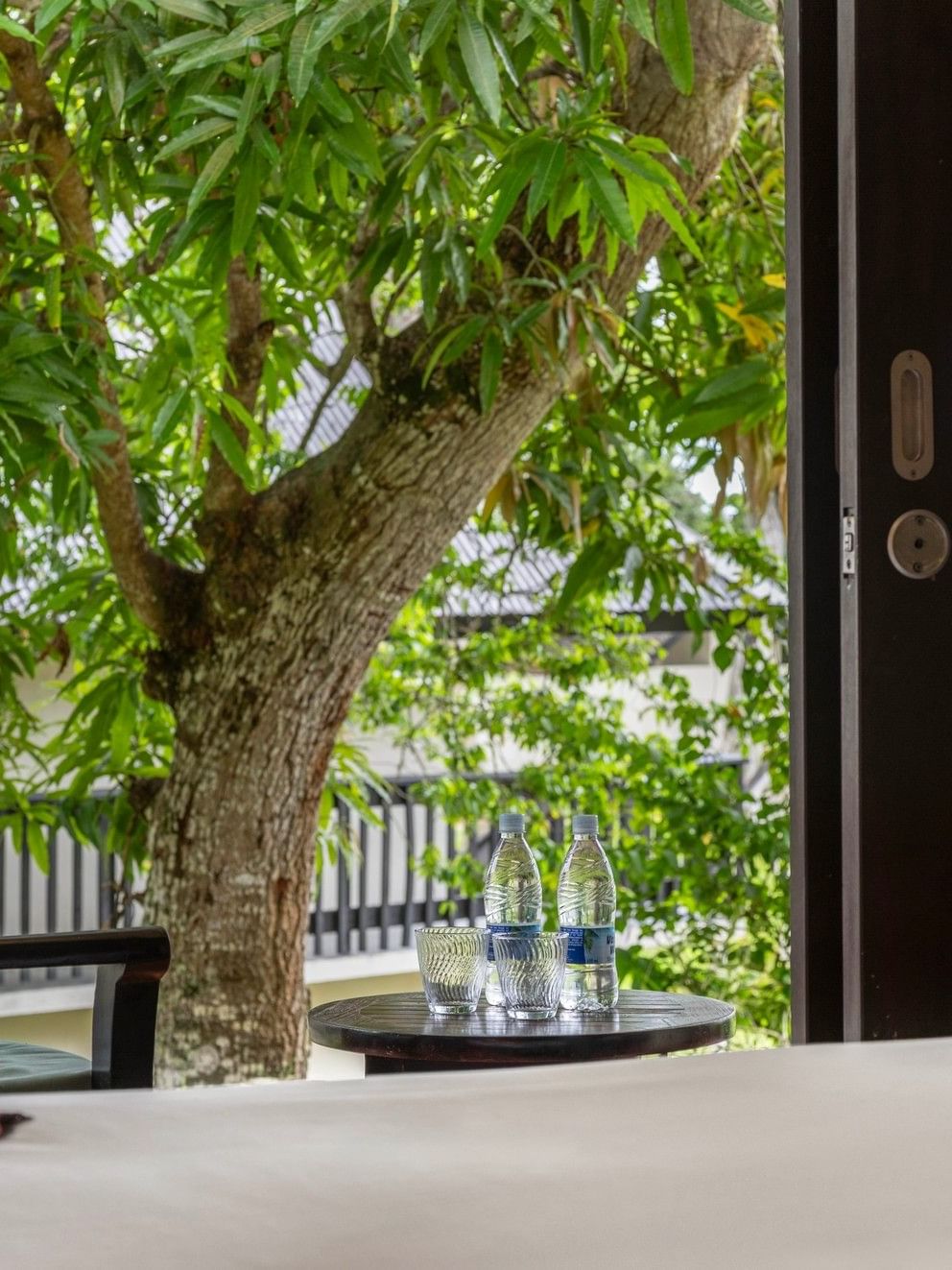 Garden View Room with patio and lush greenery at Warwick Le Lagon - Vanuatu, Efate.