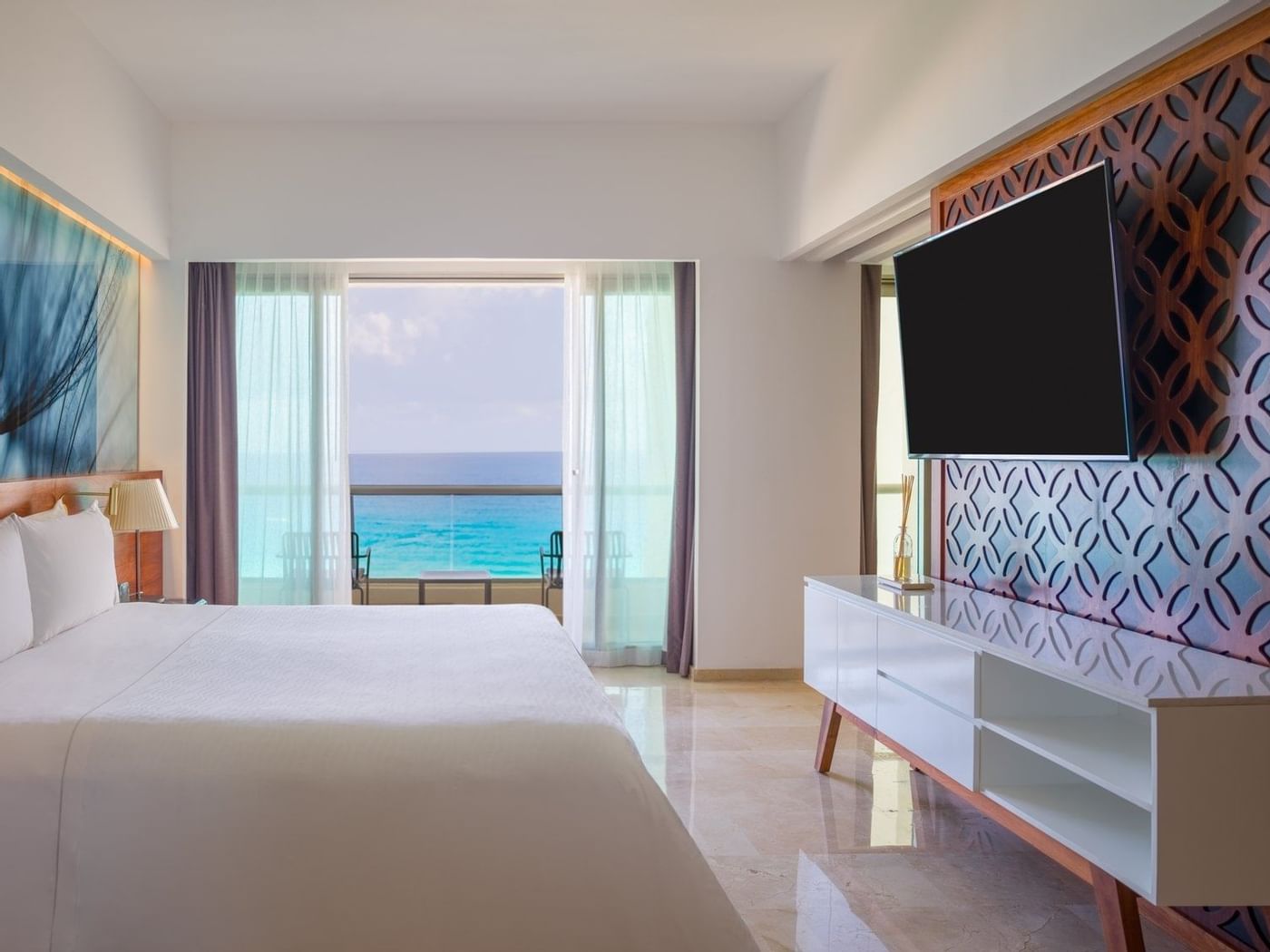 Viento Suite bedroom with king bed faced TV and sea view at Live Aqua Beach Resort Cancun