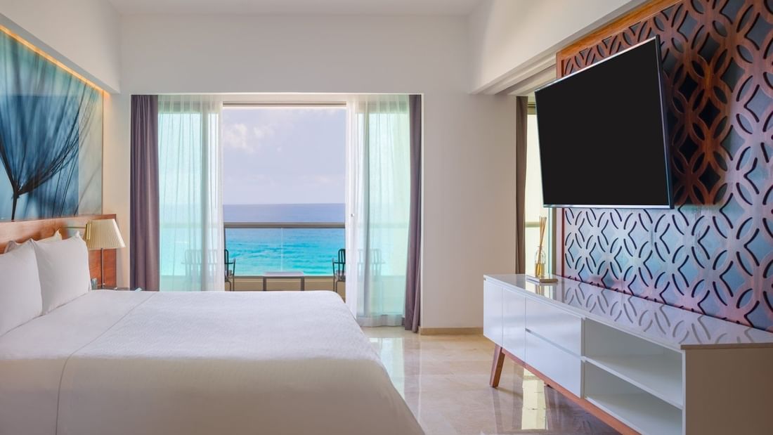 Viento Suite bedroom with king bed faced TV and sea view at Live Aqua Beach Resort Cancun