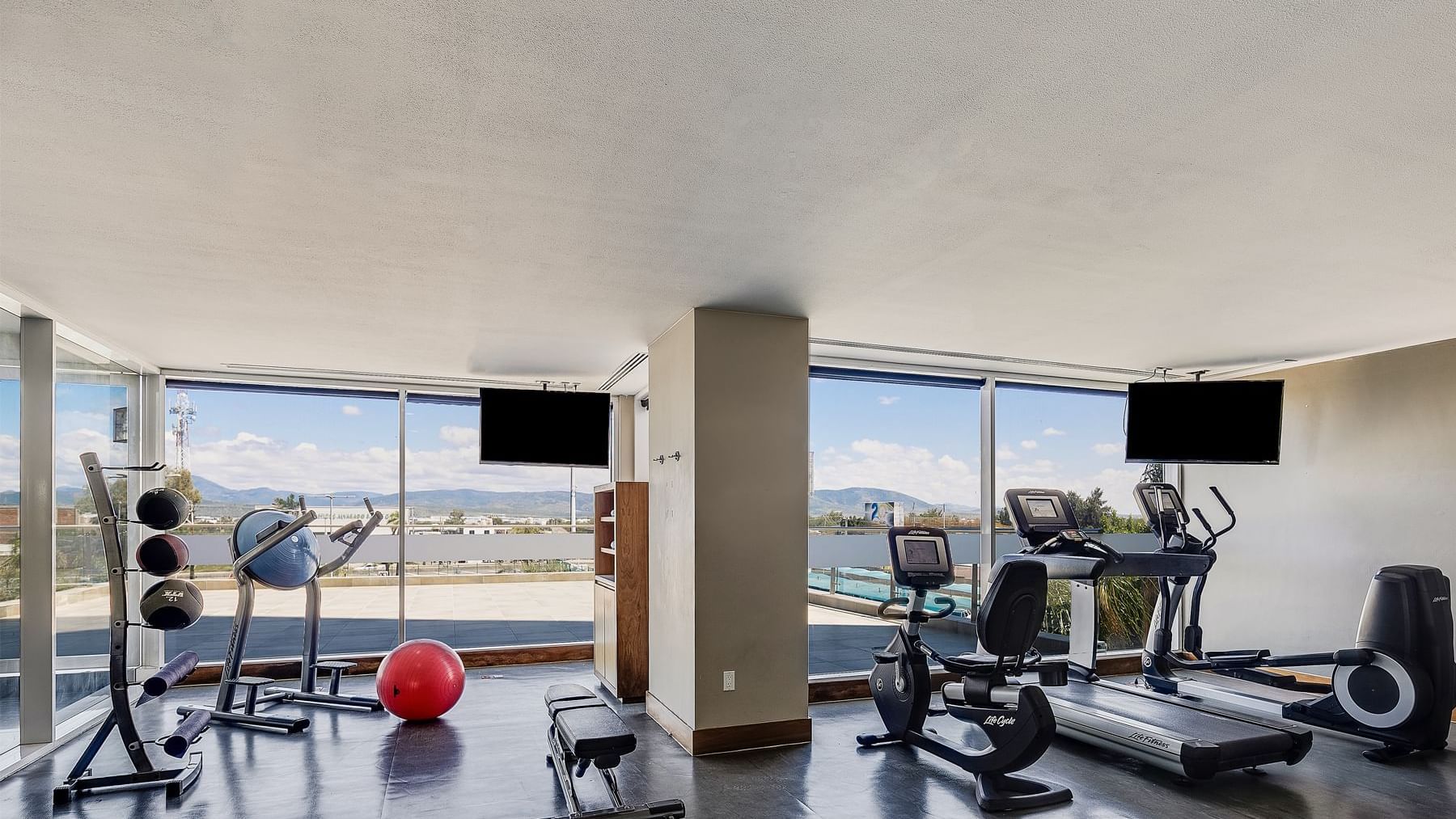 Various gym equipment in the Gym at Fiesta Inn Suites Aeropuerto del Bajío Silao