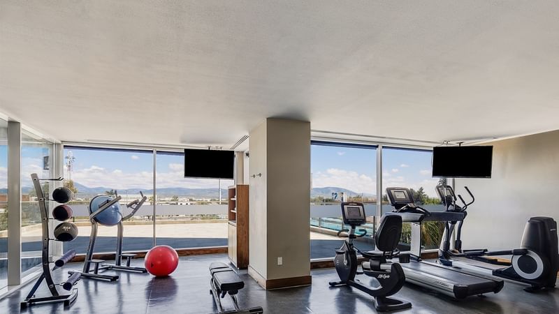 Various gym equipment in the Gym at Fiesta Inn Suites Aeropuerto del Bajío Silao