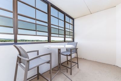 Cozy balcony with two high chairs and a circular table in Queen Resort View at Off Shore Resort