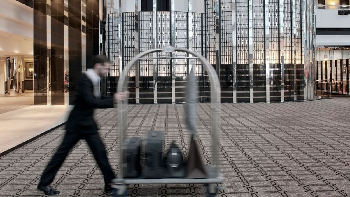 A server taking guest luggage at Crown Hotels Perth  