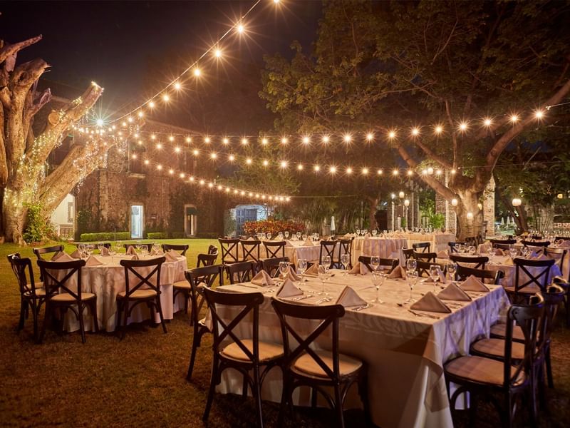 Outdoor event arrangement with illuminated lights at night, Fiesta Americana