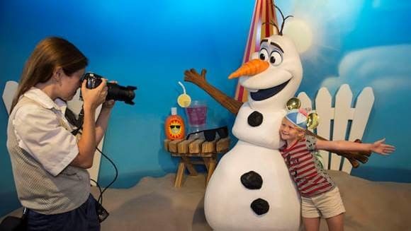 Child posing with an Olaf character figure for a photo at Lake Buena Vista Resort Village & Spa