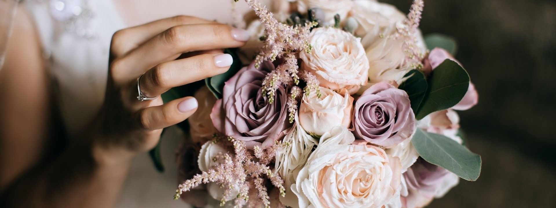 Bride holding a bouquet with pink roses and green leaves in Meeting Room A at Warwick Hotel Jeddah