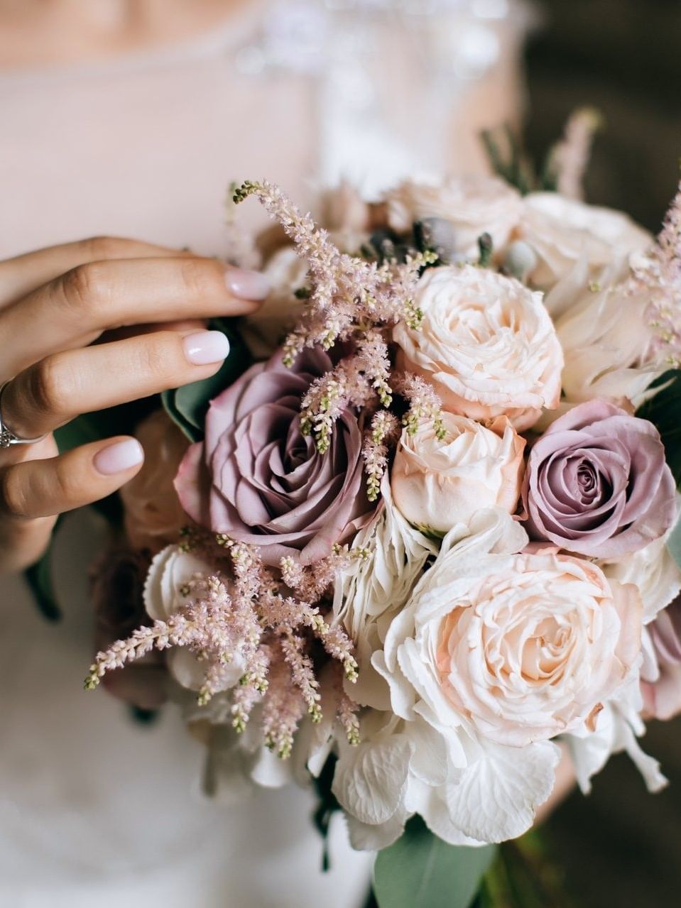 Bride holding a bouquet of pink roses and green leaves in Meeting Room C (A+B) at Warwick Hotel Jeddah
