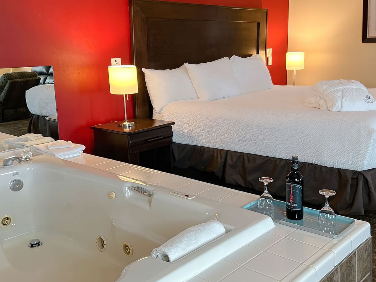 Jacuzzi tub and bed in hotel suite