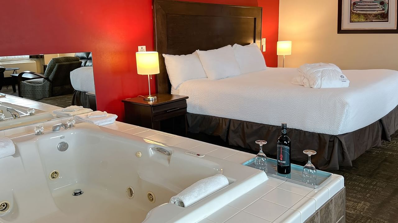 Jacuzzi tub and bed in hotel suite