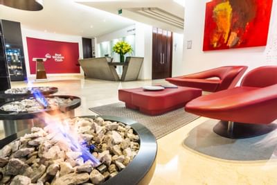 The lobby area with red couches and a fireplace