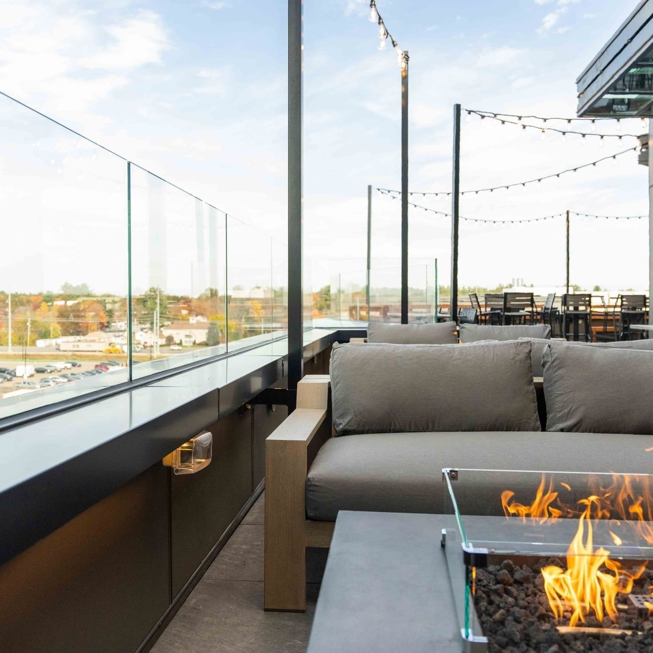 Rooftop lounge area by a firepit at The Artisan Hotel at Tuscan Village